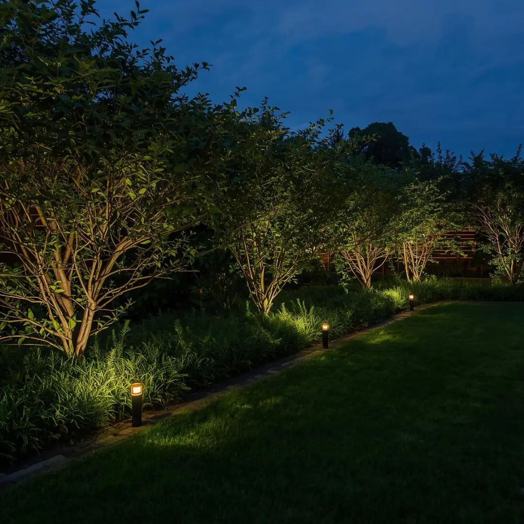 Luxury garden at twilight with LED uplights